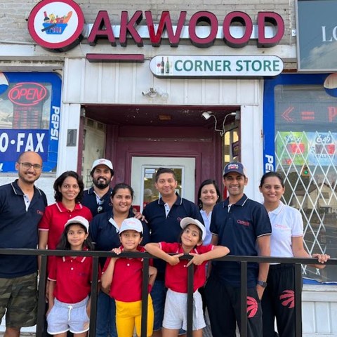 Guru Bhat at Oakwood Corner Store with community members