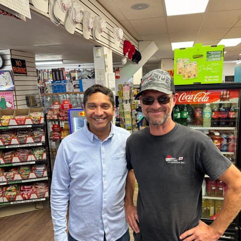 Guru Bhat with local resident at Oakwood Corner Store