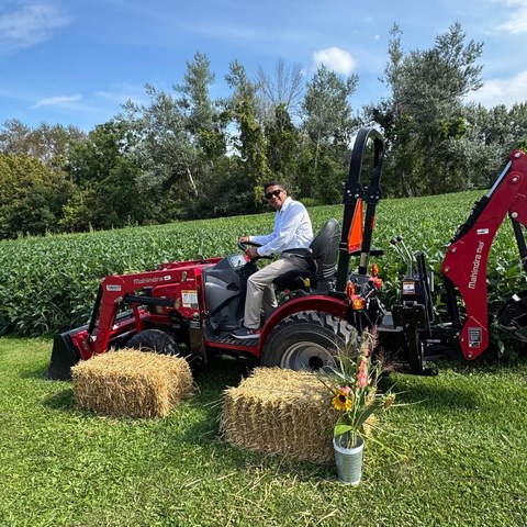 Guru Bhat on Mahindra tractor at Ward 4 farm